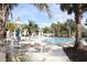 Resort-style pool with a splash pad, clubhouse, lounge chairs and mature palms at 14352 Editors Note St, Ruskin, FL 33573