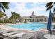 Resort-style community pool with a clubhouse, poolside seating and palm trees at 14352 Editors Note St, Ruskin, FL 33573