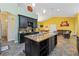 Open kitchen with a granite island and dark wood cabinets adjacent to a living room at 15618 Phillips Rd, Odessa, FL 33556