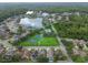 Lakefront community featuring a pool, playground, basketball and tennis courts, and mature trees at 15807 Leatherleaf Ln, Land O Lakes, FL 34638
