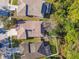 A high aerial shot shows the arrangement of houses with brown roofs and green lawns at 15807 Leatherleaf Ln, Land O Lakes, FL 34638