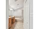 Bright bathroom featuring tile flooring, a soaking tub, a separate shower, and a double vanity at 15807 Leatherleaf Ln, Land O Lakes, FL 34638