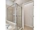 Bright bathroom featuring tiled shower with glass doors and tiled tub surround at 15807 Leatherleaf Ln, Land O Lakes, FL 34638