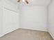 Large bedroom featuring ceiling fan, neutral walls, and a spacious closet at 15807 Leatherleaf Ln, Land O Lakes, FL 34638