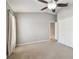 Neutral bedroom with carpet, a ceiling fan, double door closet, and a window at 15807 Leatherleaf Ln, Land O Lakes, FL 34638