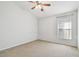 Bright bedroom featuring neutral walls, plush carpeting, and ceiling fan at 15807 Leatherleaf Ln, Land O Lakes, FL 34638