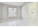 Neutral bedroom with tiled floor and access to laundry room at 15807 Leatherleaf Ln, Land O Lakes, FL 34638