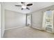 Spacious bedroom with plush carpeting, neutral walls, and a ceiling fan for added comfort at 15807 Leatherleaf Ln, Land O Lakes, FL 34638