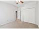 This bedroom offers neutral carpet, light walls, closet storage and a view into an adjacent room at 15807 Leatherleaf Ln, Land O Lakes, FL 34638