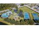 Aerial view of community pool, playground, tennis and basketball courts, and green spaces at 15807 Leatherleaf Ln, Land O Lakes, FL 34638