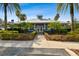 Inviting community clubhouse featuring a covered entrance, a well-kept lawn and landscaping at 15807 Leatherleaf Ln, Land O Lakes, FL 34638