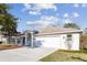 Charming single-Gathering home featuring a spacious two-car garage and well-maintained lawn on a sunny day at 15807 Leatherleaf Ln, Land O Lakes, FL 34638