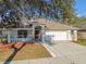 Charming single-story home featuring a two-car garage, well-manicured lawn, and neutral color palette at 15807 Leatherleaf Ln, Land O Lakes, FL 34638