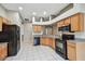 Well-lit kitchen featuring light wood cabinets and black appliances at 15807 Leatherleaf Ln, Land O Lakes, FL 34638
