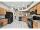 Bright kitchen with white tile flooring and a modern layout at 15807 Leatherleaf Ln, Land O Lakes, FL 34638