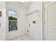 Bright laundry room with window and wire shelving at 15807 Leatherleaf Ln, Land O Lakes, FL 34638