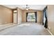 Open living room with carpet, tile entryway, and ample natural light from large window at 15807 Leatherleaf Ln, Land O Lakes, FL 34638