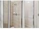 Modern shower with glass door and tiled walls, offering a clean and stylish design at 15807 Leatherleaf Ln, Land O Lakes, FL 34638