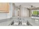 Close-up of the kitchen sink with stainless steel fixtures and a neutral countertop at 15807 Leatherleaf Ln, Land O Lakes, FL 34638