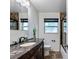 Updated bathroom with elegant marble vanity, decorative tile, shower with glass door, and updated fixtures at 1612 Suffolk Dr, Clearwater, FL 33756