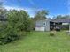 Backyard view with a shed and mature trees at 16240 Lake Palm Dr, Lutz, FL 33549