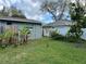 Spacious backyard with a mix of trees and a white vinyl fence at 16240 Lake Palm Dr, Lutz, FL 33549