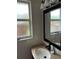 Cozy bathroom featuring a vanity with granite counters, a mirror, and natural light at 16240 Lake Palm Dr, Lutz, FL 33549