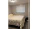 A cozy bedroom featuring a comfortable bed and natural light from the window at 16240 Lake Palm Dr, Lutz, FL 33549