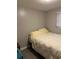 A cozy bedroom featuring a comfortable bed and a window at 16240 Lake Palm Dr, Lutz, FL 33549