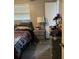 Cozy bedroom featuring a comfortable bed, nightstand, and soft lighting at 16240 Lake Palm Dr, Lutz, FL 33549