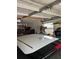 Functional garage with overhead storage, a window and an automated door provides secure parking and additional storage options at 16240 Lake Palm Dr, Lutz, FL 33549