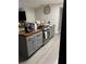 Kitchen with gray cabinets, stainless steel oven, butcher block counters and modern fixtures at 16240 Lake Palm Dr, Lutz, FL 33549