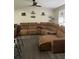 Spacious living room with a large sectional sofa and a ceiling fan at 16240 Lake Palm Dr, Lutz, FL 33549
