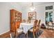 Elegant dining room featuring a classic table setting, vintage hutch, and sophisticated decor at 17138 Downs Dr, Odessa, FL 33556