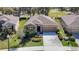 Aerial view of house with a well-maintained lawn, lush landscaping, and access to golf course at 17749 Garsalaso Cir, Brooksville, FL 34604
