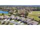 Aerial view of home with golf course and water views in a lush community at 17749 Garsalaso Cir, Brooksville, FL 34604