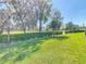 Lush green backyard with manicured hedges and mature trees at 17749 Garsalaso Cir, Brooksville, FL 34604