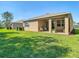 Spacious backyard with green lawn and covered patio perfect for outdoor gatherings at 17749 Garsalaso Cir, Brooksville, FL 34604
