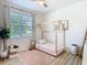 Bright bedroom with house frame bed, large window, hardwood flooring and natural light at 17749 Garsalaso Cir, Brooksville, FL 34604