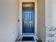 Elegant front door with stone columns and a glass transom window, creating a welcoming entrance at 17749 Garsalaso Cir, Brooksville, FL 34604