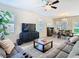 Spacious living room featuring lots of natural light, a ceiling fan, and an open-concept layout at 17749 Garsalaso Cir, Brooksville, FL 34604