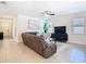 Comfortable living room with neutral tile flooring, ceiling fan, and modern furnishings at 17749 Garsalaso Cir, Brooksville, FL 34604