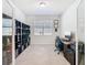 Bright office with a desk setup, black shelving, and large window at 17749 Garsalaso Cir, Brooksville, FL 34604