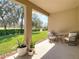Covered patio with outdoor seating overlooking green lawn and mature trees at 17749 Garsalaso Cir, Brooksville, FL 34604