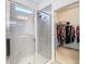 Modern shower with glass door, bench seating, and access to a spacious walk-in closet at 17749 Garsalaso Cir, Brooksville, FL 34604