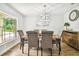 Dining room with a wooden table, seating for six, and a decorative light fixture at 1805 Parkwood Dr, Valrico, FL 33594