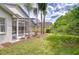 Screened-in back porch with palm trees and a lush green lawn provides a perfect outdoor entertaining area at 18828 Rue Loire, Lutz, FL 33558