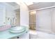 Bathroom featuring a vessel sink and a shower-over-tub combination with a glass door at 18828 Rue Loire, Lutz, FL 33558