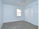 Empty bedroom featuring a carpet floor, a window and a closet with white doors at 18828 Rue Loire, Lutz, FL 33558