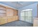 Bedroom featuring a carpet floor, a ceiling fan, and custom built-in shelves and cabinets at 18828 Rue Loire, Lutz, FL 33558